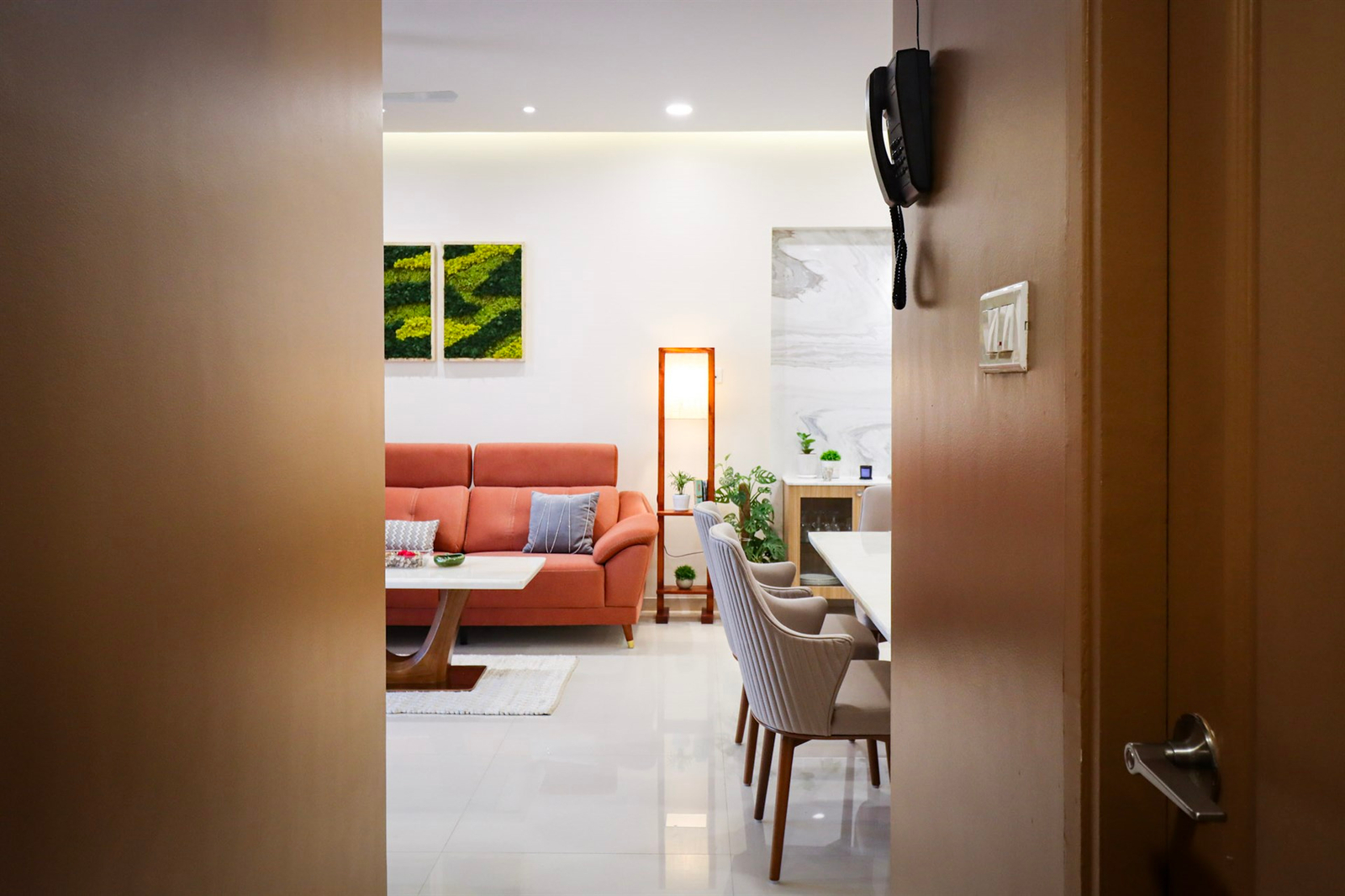 a room with a couch and dining table