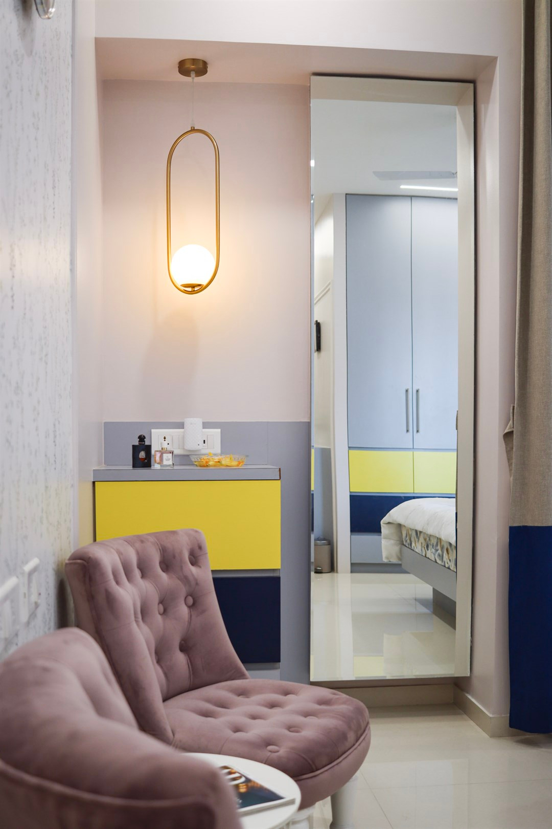 a room with a mirror and a chair