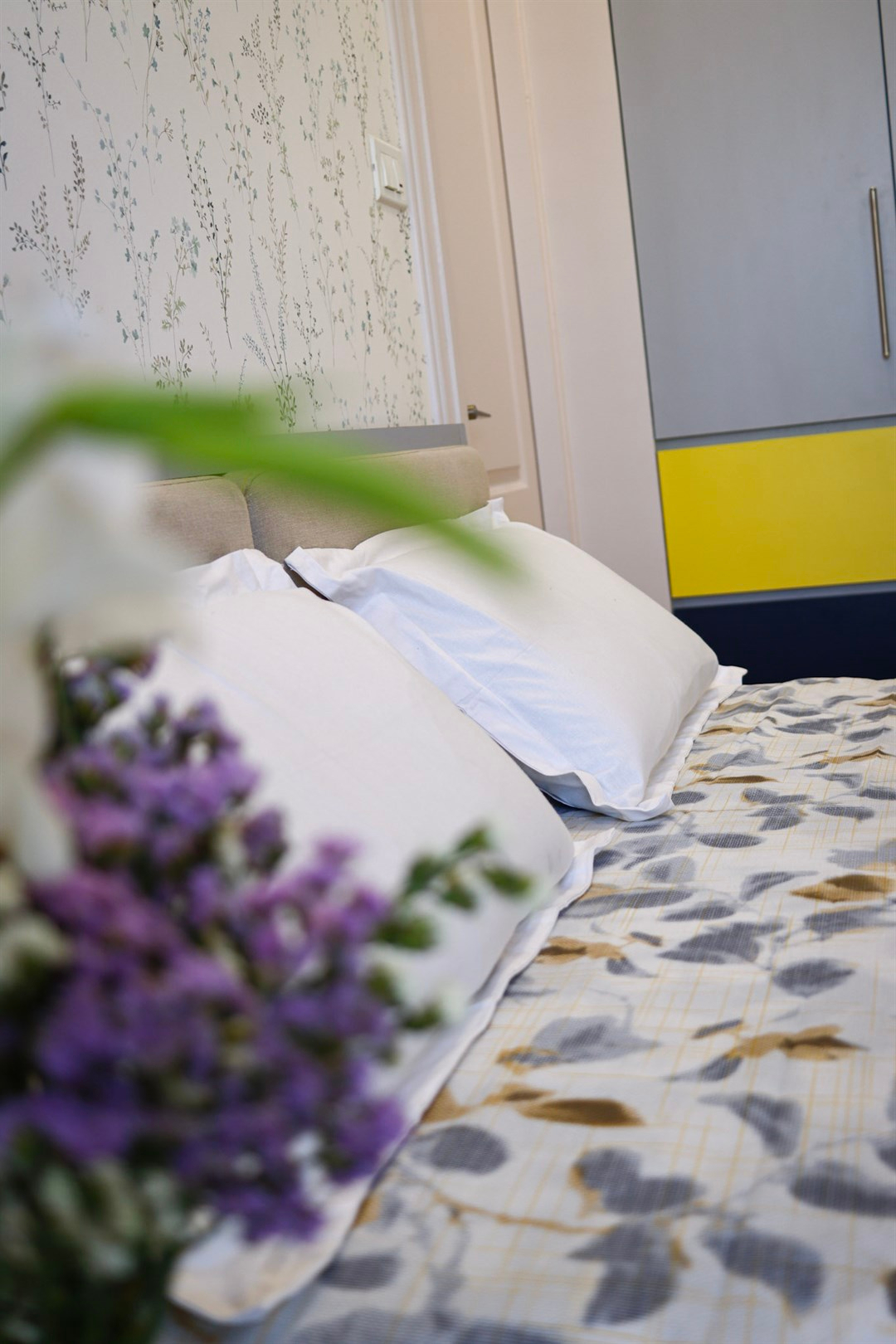 a bed with pillows and flowers