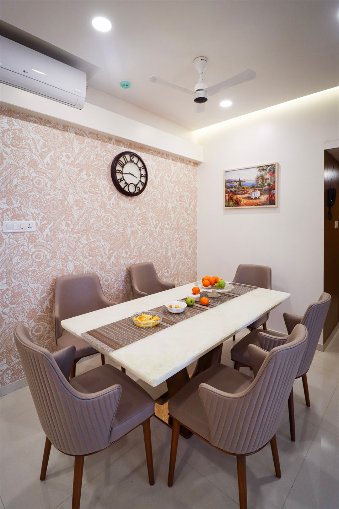 a table with fruit on it and chairs around it