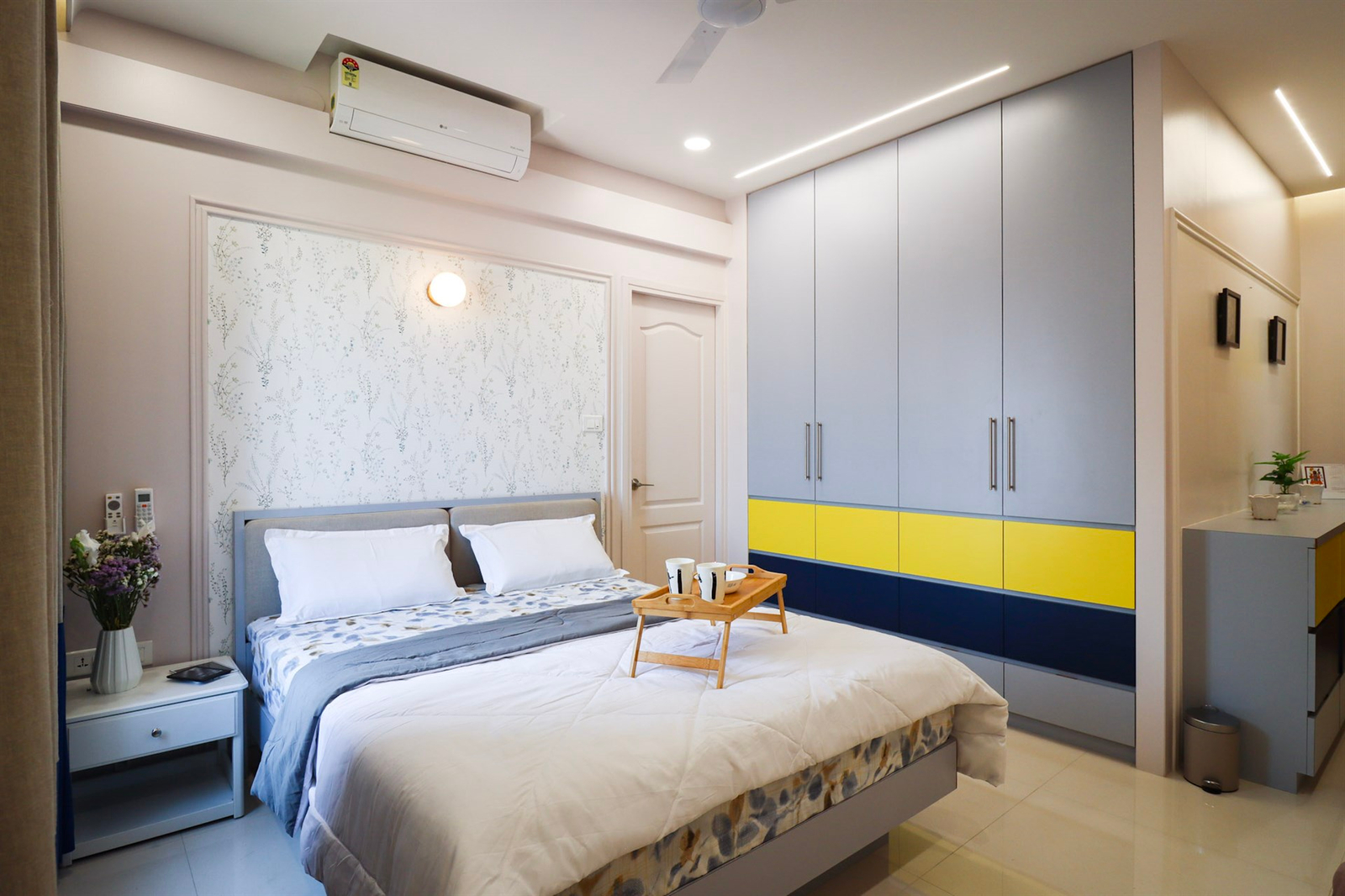 a bed with a tray of coffee on it