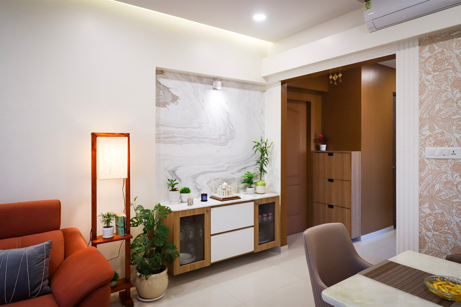 a room with a marble wall and a table and chairs