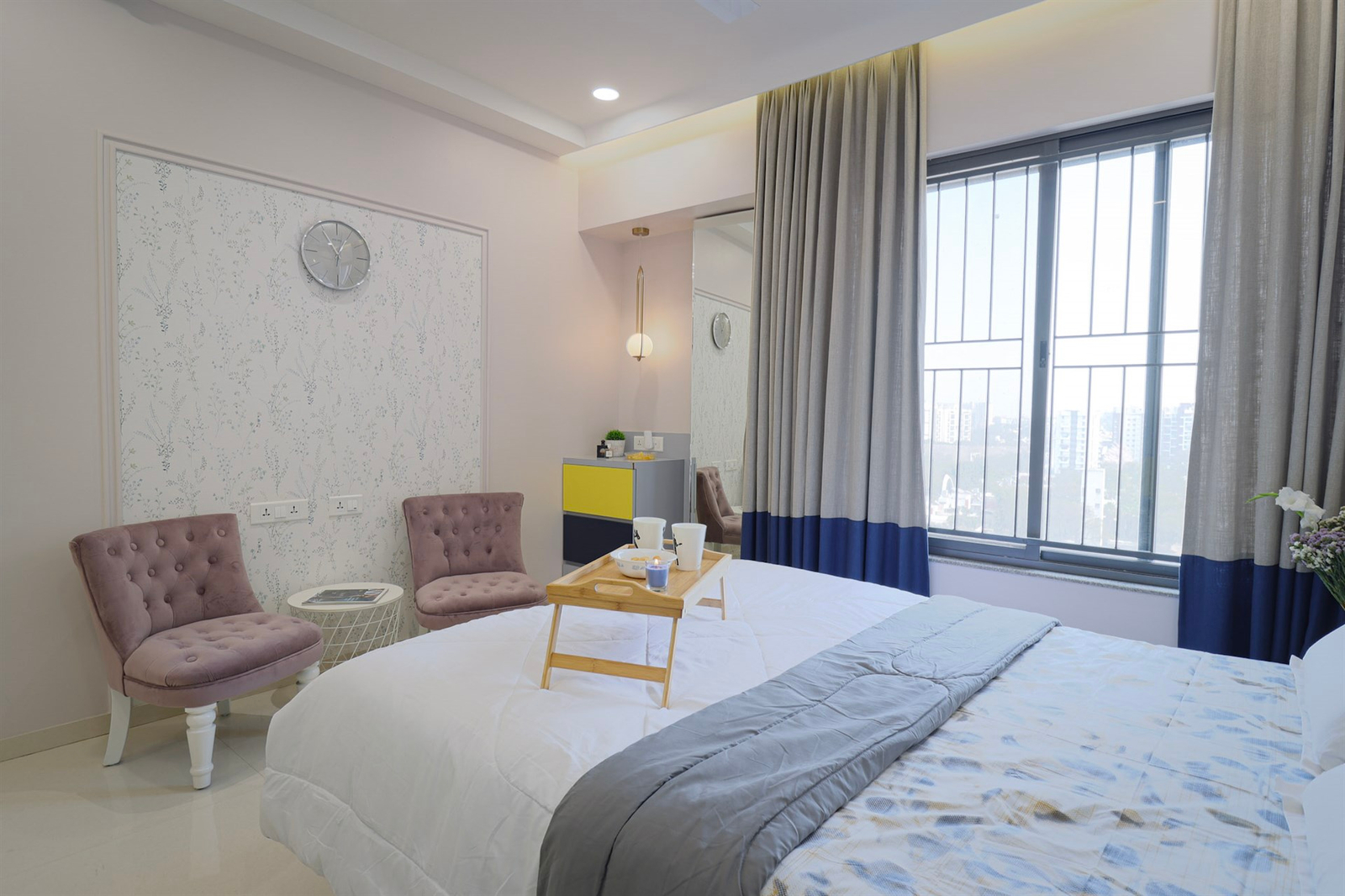 a bedroom with a bed and chairs