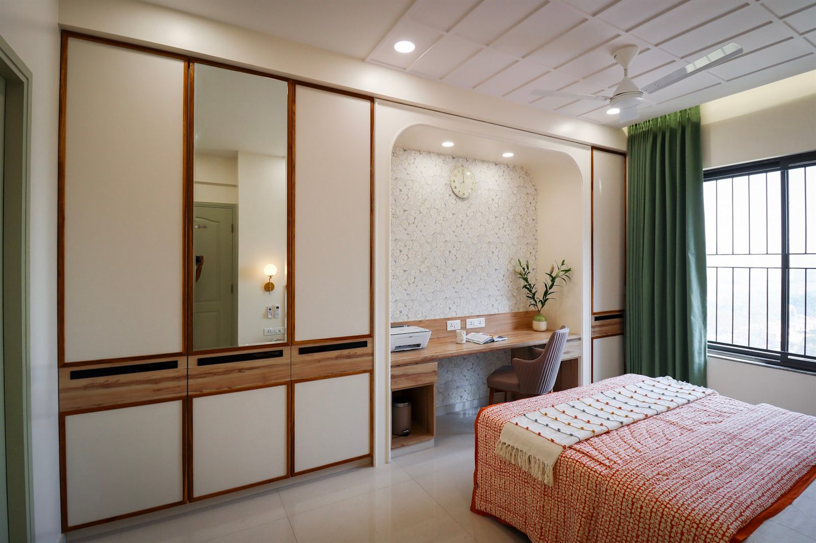 a bedroom with a desk and a mirror